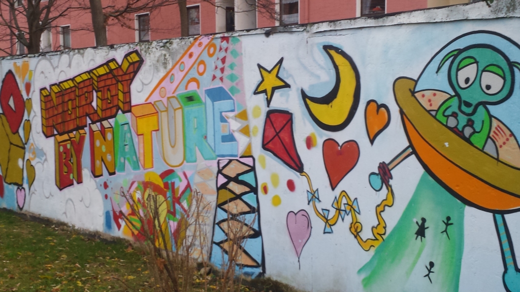 Eine Mauer mit Graffiti. Auf der Mauer steht in bunten Farben: "Nordy by Nature".